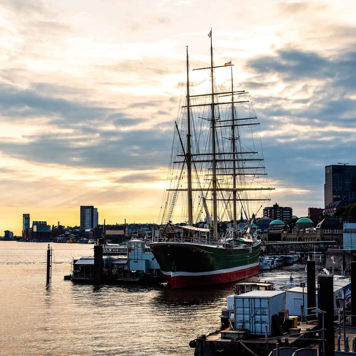 Historic sailing ship in Hamburg harbor at sunset